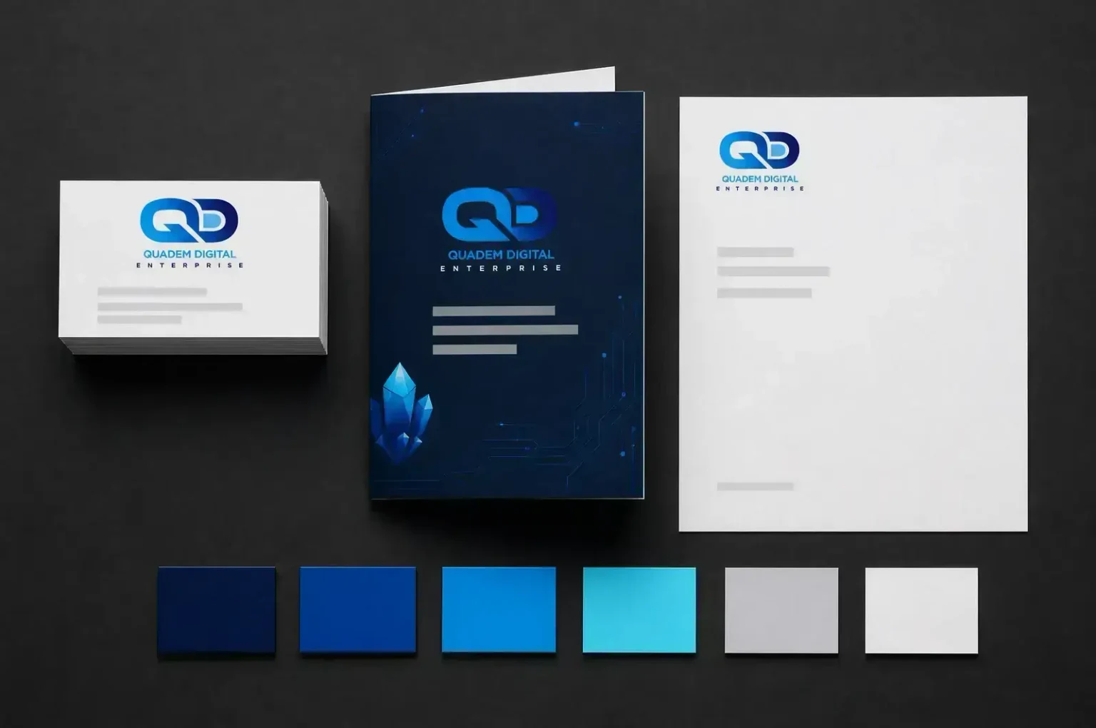 Quadem Digital’s own blue identity system, with its QD logo, stationery and colour palette.